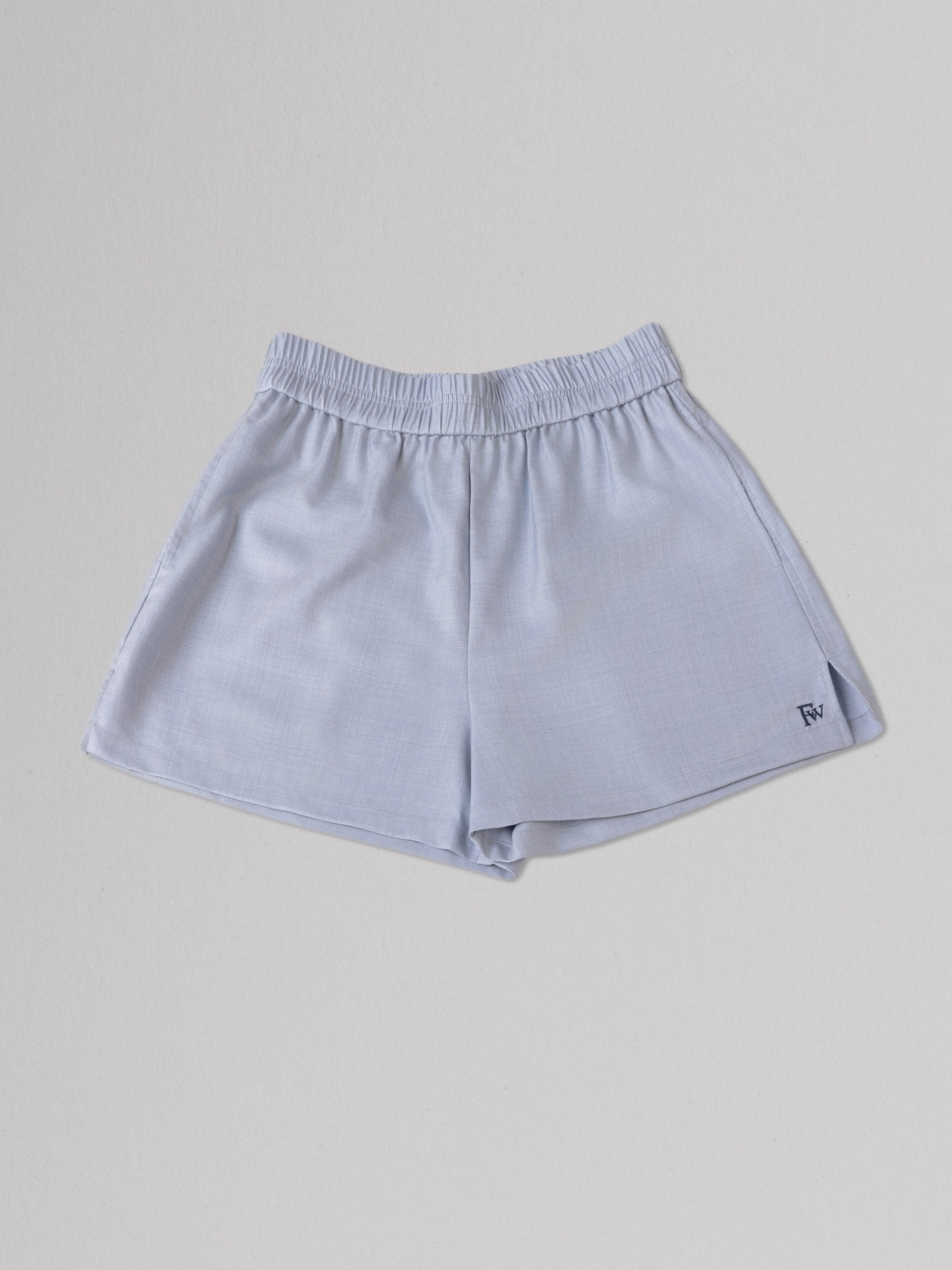 Light blue shorts on a gray background