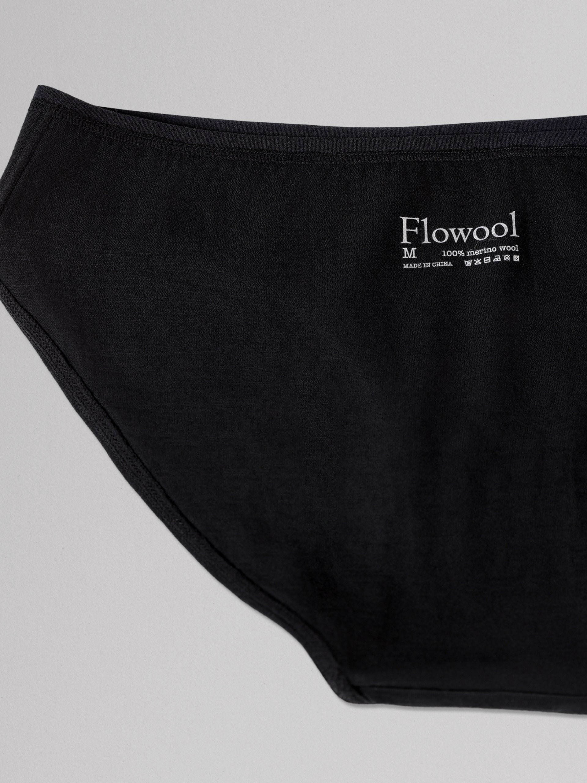 Black underwear with 'Flowool' brand label on a light gray background