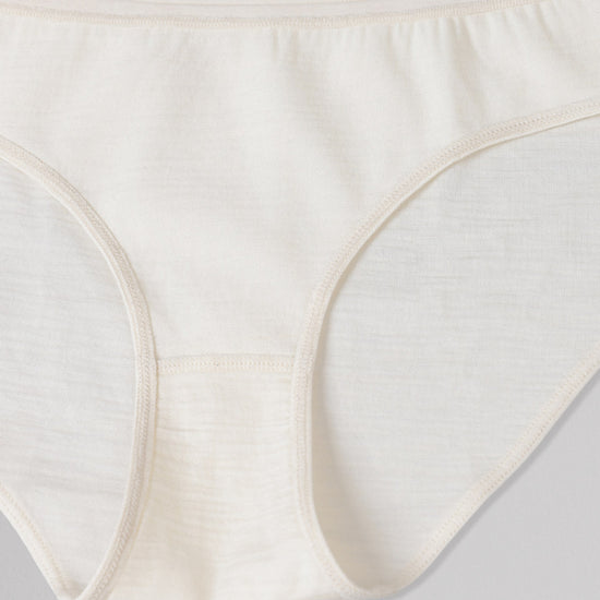 Close-up of off white women's underwear on a light gray background