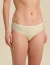 Person wearing sand bikini brief against a neutral background.