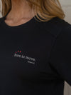 Black t-shirt with 'Born to move' text and red heart design on a blurred background
