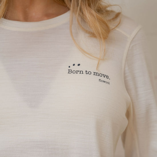 White long-sleeve shirt with 'Born to move' text on a neutral background