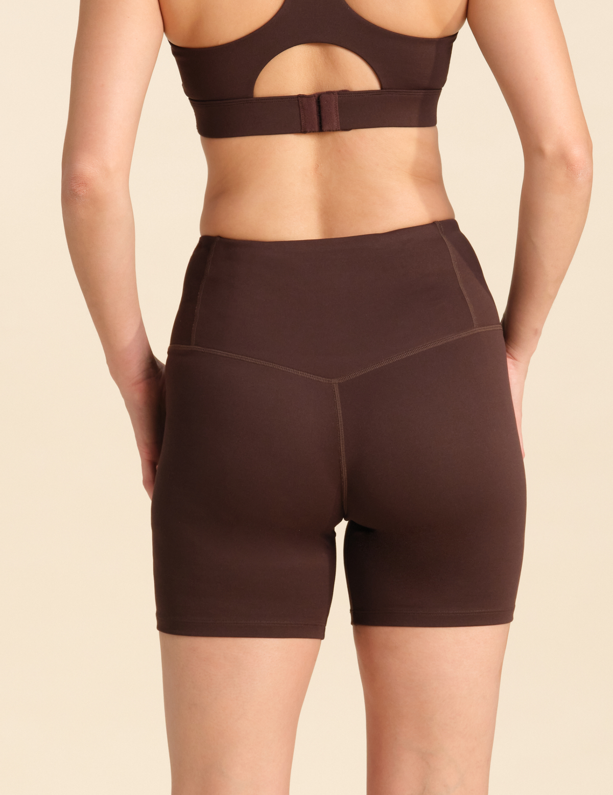 Back view of person wearing chocolate flex sports shorts against a neutral background.
