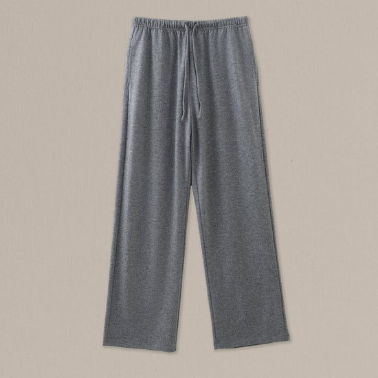 Women's grey heather merino wool straight-leg pant on a neutral sand background.