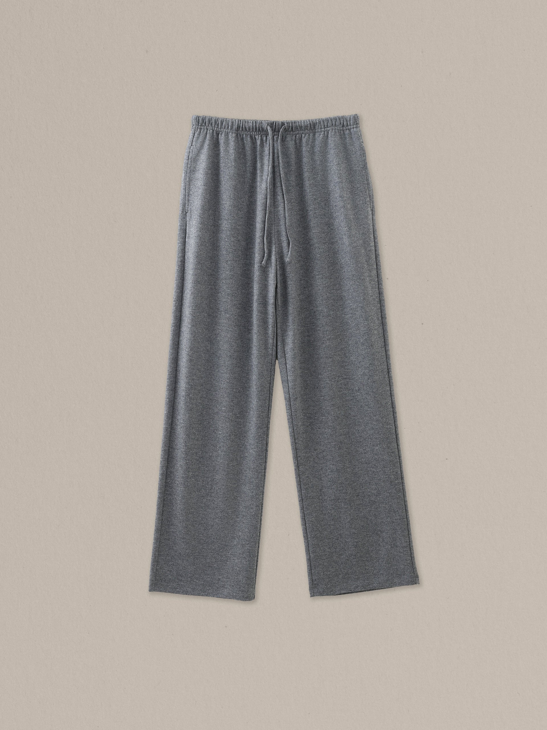 Women's grey heather merino wool straight-leg pant on a neutral sand background.