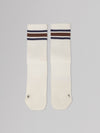 Two white socks with brown and blue stripes on a gray background
