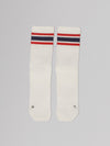 Pair of white socks with red and blue stripes on a gray background