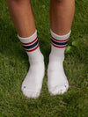 White socks with red and blue stripes worn on grass
