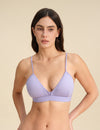 Woman wearing a lavender Merino wool triangle bra against the background.