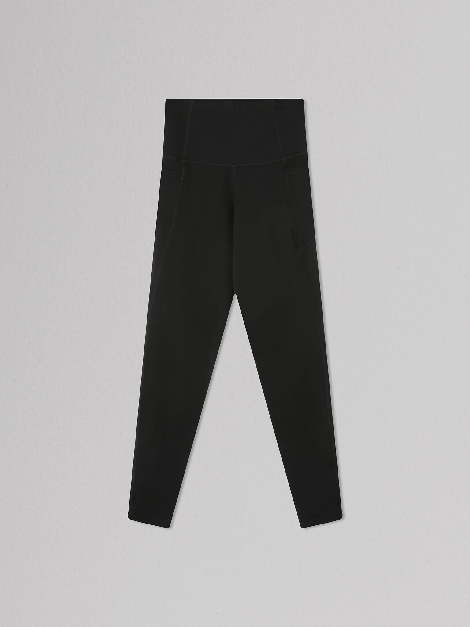 High-waisted black leggings with side pockets, displayed on a light gray background, suitable for activewear or casual wear.